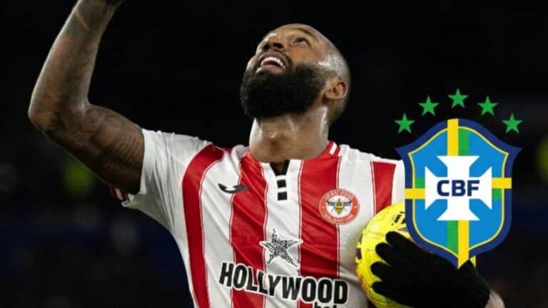 Igor Thiago celebrando un gol en la Premier League con el escudo de Brasil de fondo.