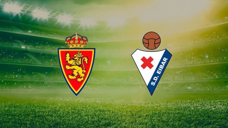 Escudos del Real Zaragoza y la SD Eibar sobre el césped de un estadio de fútbol para el partido de LaLiga Hypermotion